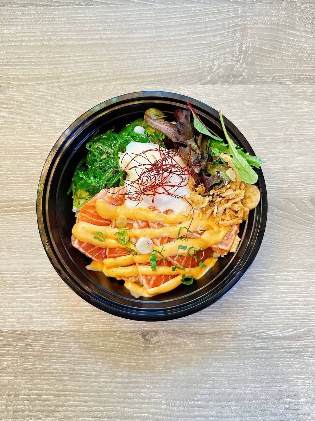 Sashimi bowl at Gyo Gyo En with salmon, hamachi, seaweed salad and a soft-boiled egg over furikake rice