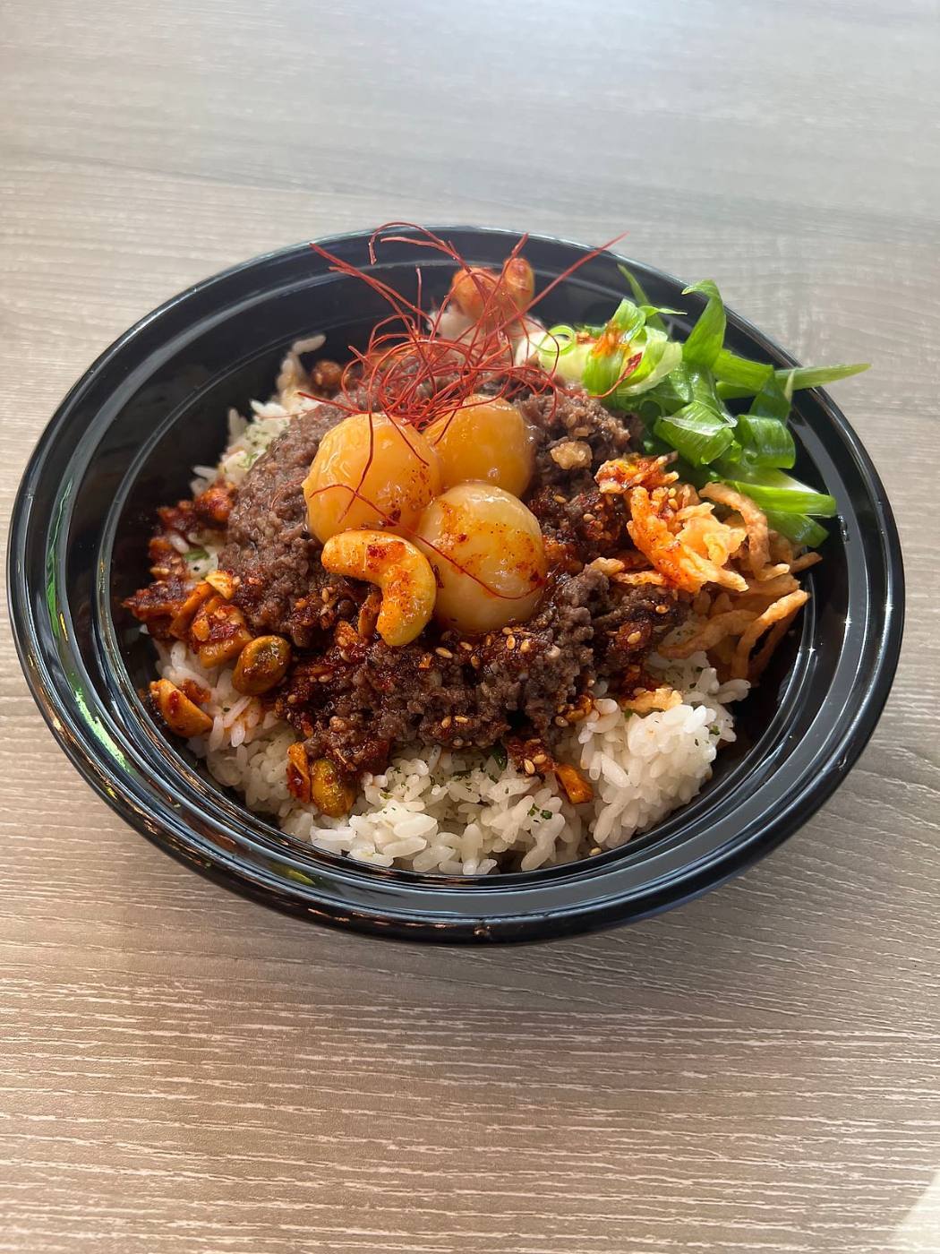 Donburi at Gyo Gyo En with seasoned ground meat, shrimp, cashews and chili threads over rice